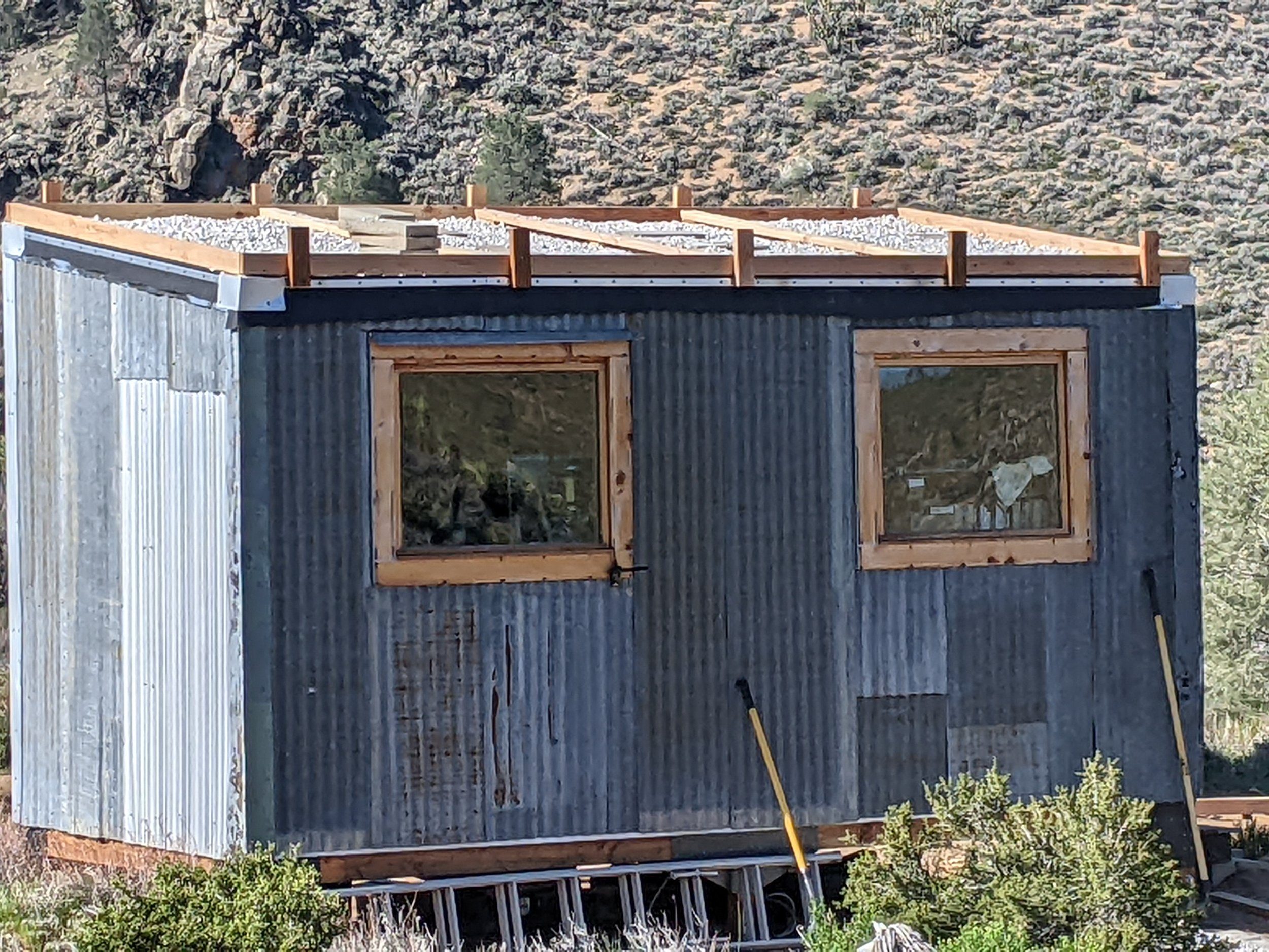 off-grid tiny house with a gravel cool roof